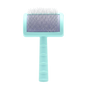 A pet grooming brush with a light mint green handle and head, featuring silver metal bristles on a purple-tinted pad, isolated on a white background.